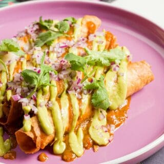 a pink plate topped with food on top of a table