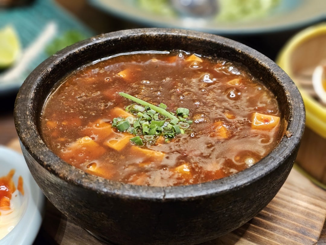 a close up of a bowl of soup on a table